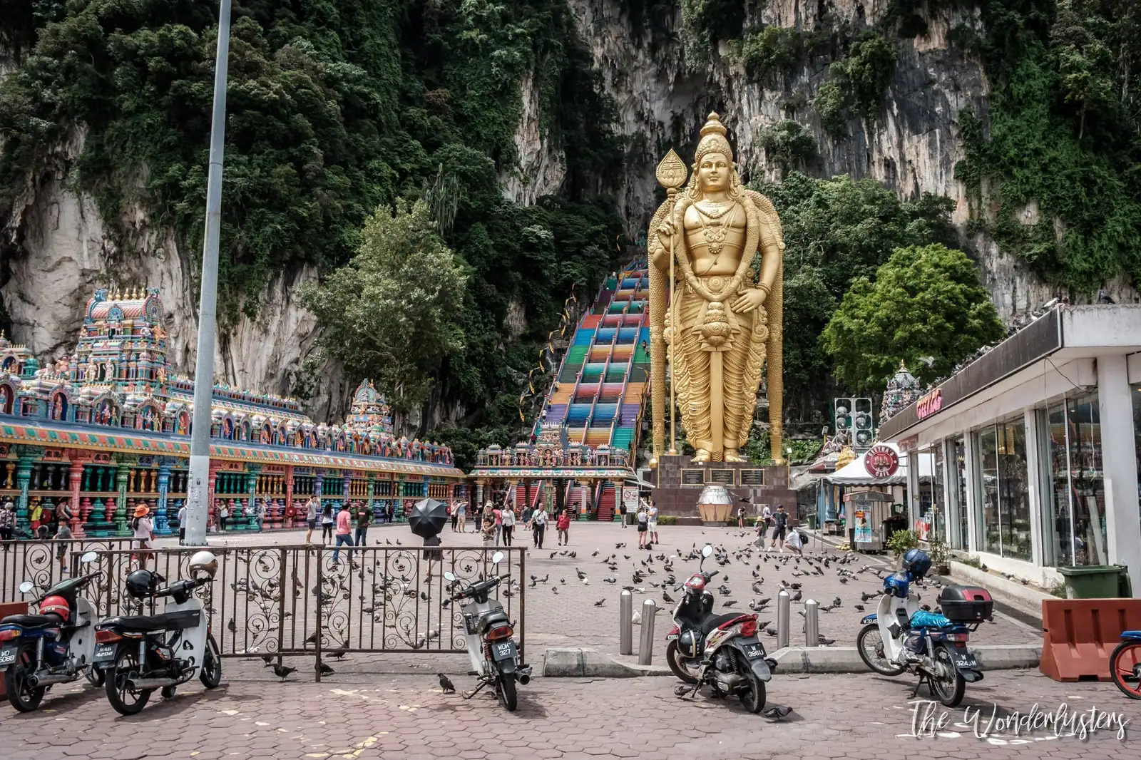 Rainbow staircase and golden Murugan statue at the Batu Caves