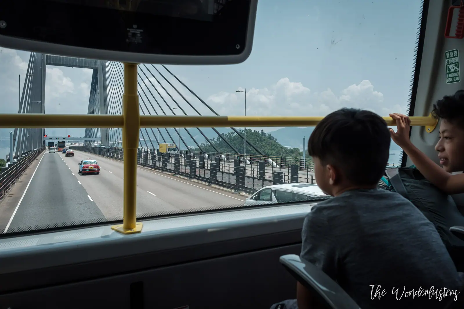 The boys on the upper deck of a double-decker bus in Hong Kong
