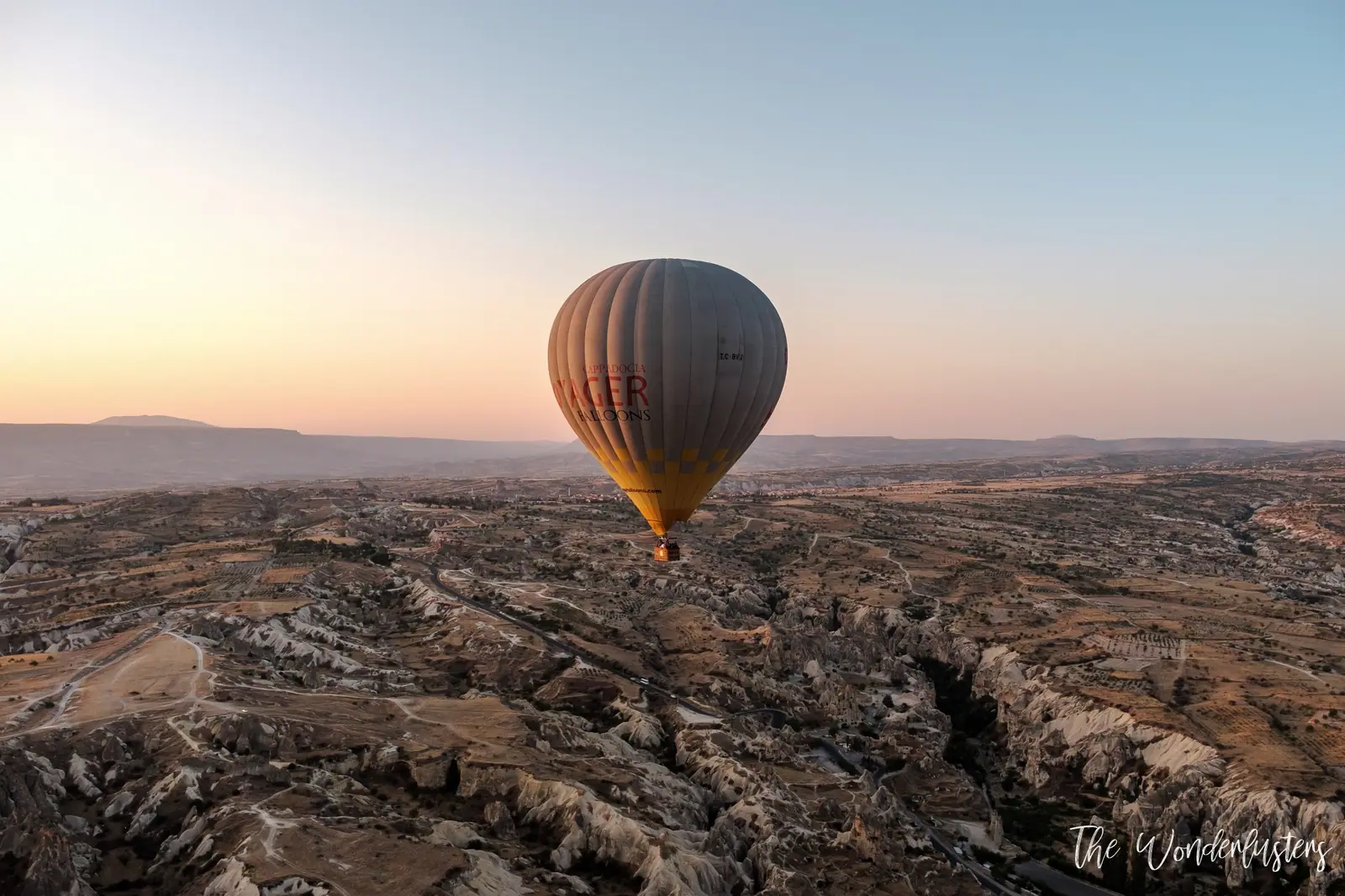 Hot air balloons drifting over Cappadocia