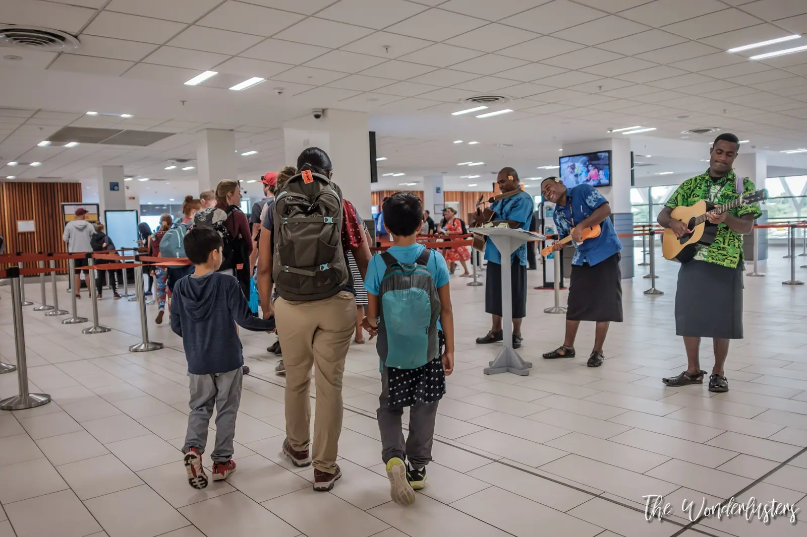 Musicians playing guitar to welcome arriving passengers at Nadi airport
