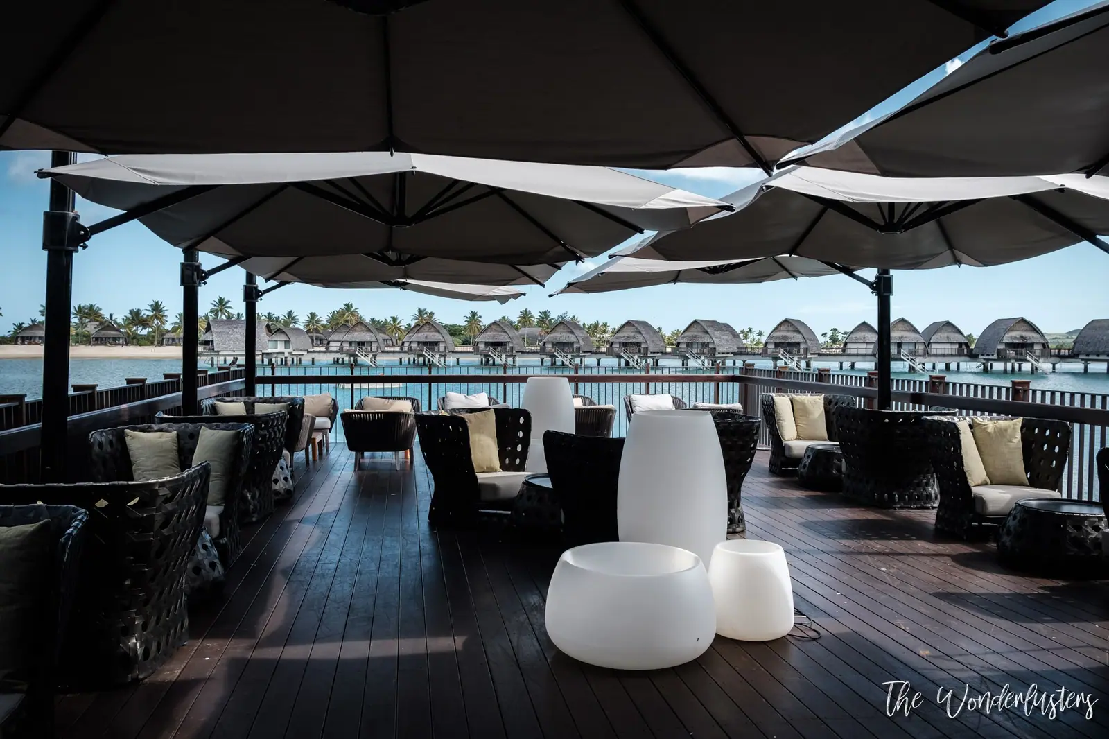 Shaded terrace overlooking the overwater bures at Momi Bay