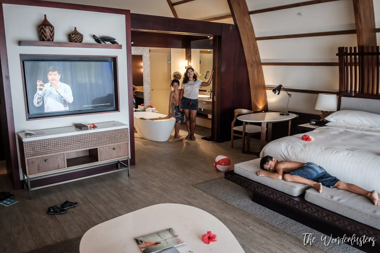 Our family settling into our spacious suite at Momi Bay