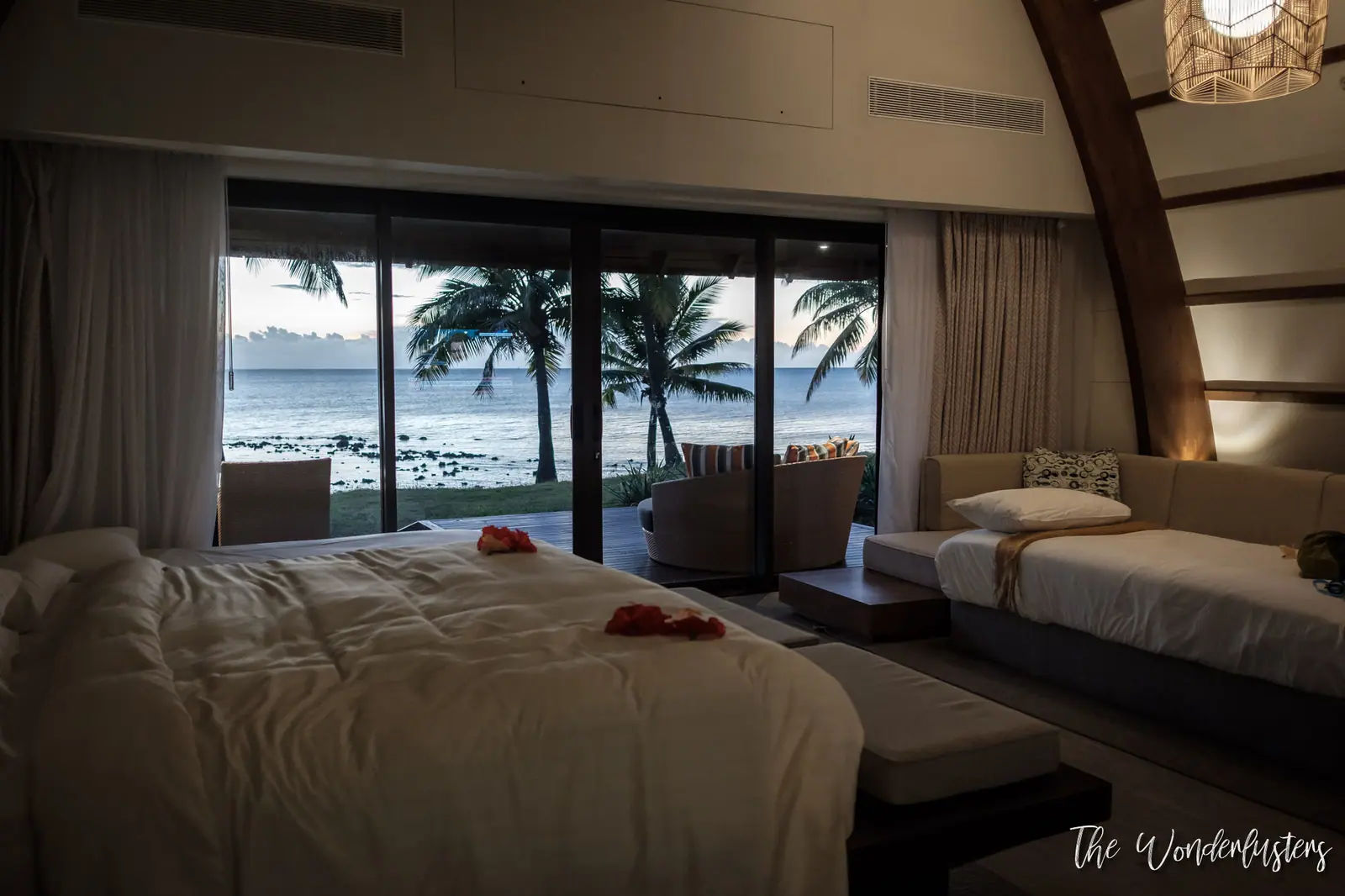 Bedroom of our suite with a sea view at dusk
